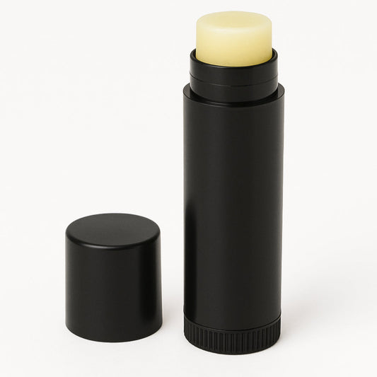 Black lip balm container with a yellow lip balm on a white background
